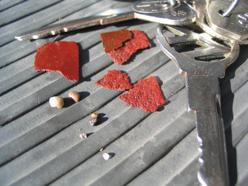 Retrieved from pan: flat, flaky reddish bits; small stones. (!)